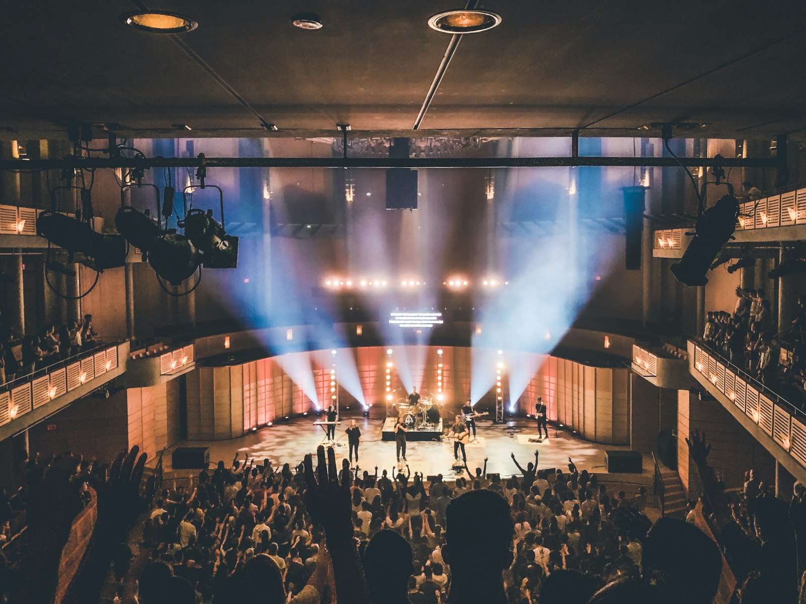 An audience gathered in a theater before a performance.