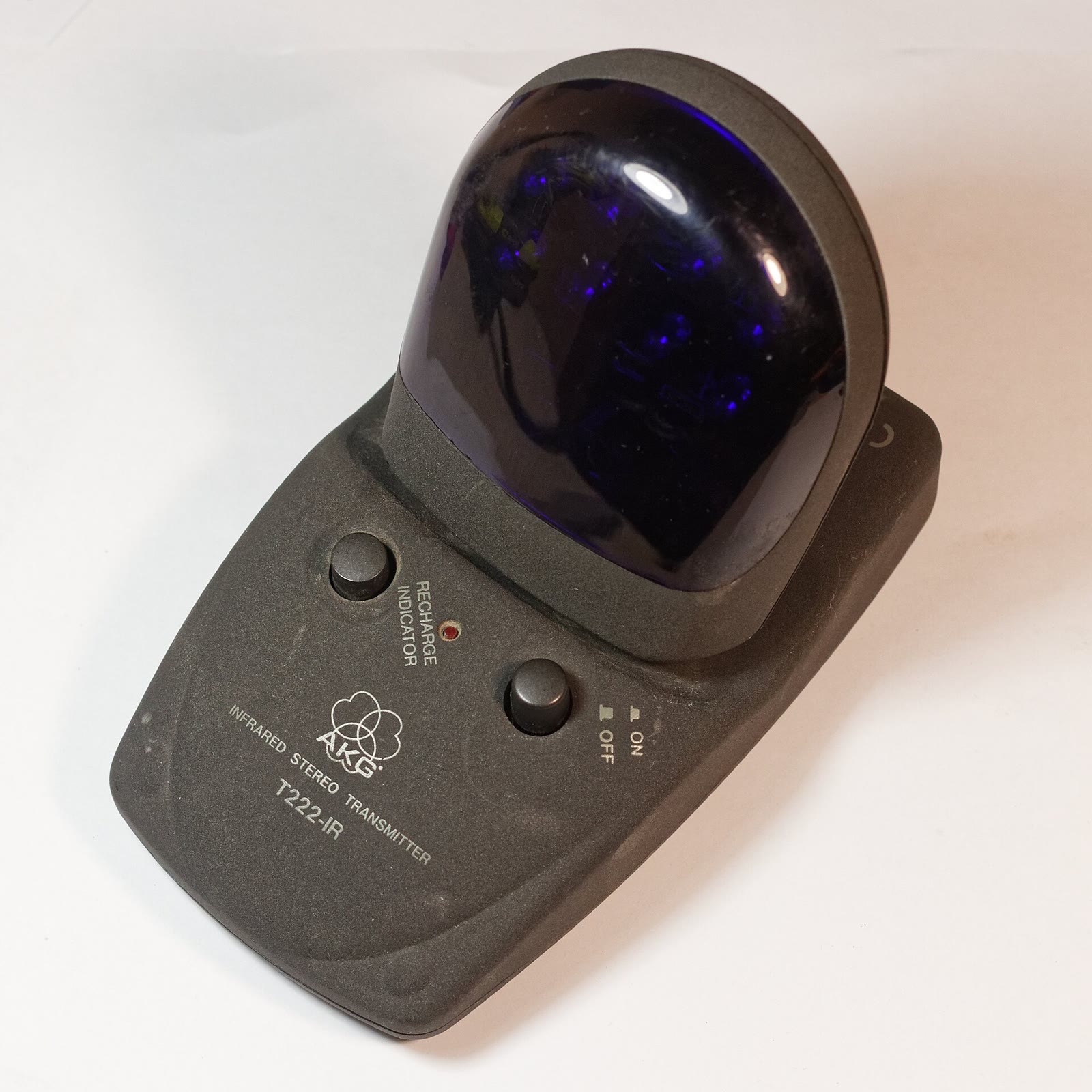 Grey AKG T222-IR infrared transmitter with a dark domed emitter on a white background