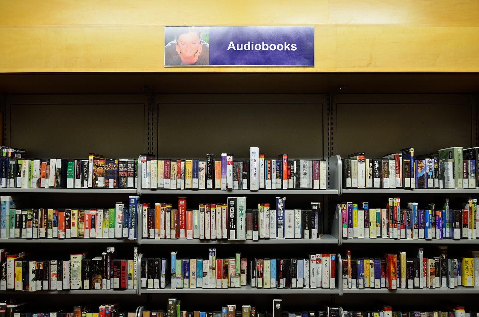 Rows of audiobook boxes on a public library shelf, photographed in 2015