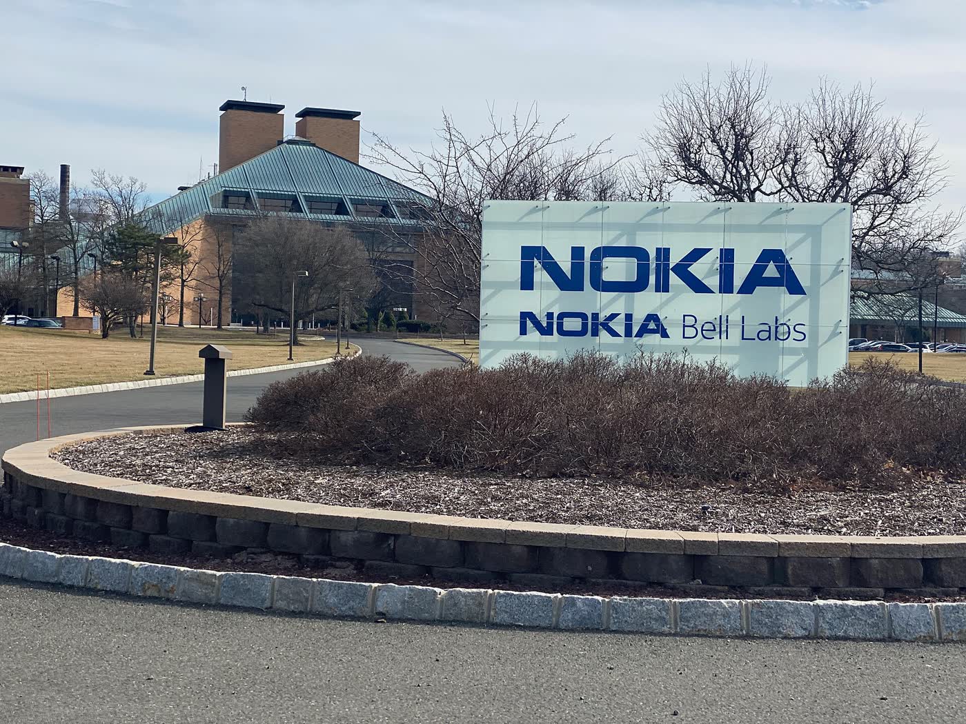 Nokia Bell Labs sign on a landscaped roundabout in front of the Murray Hill laboratory buildings