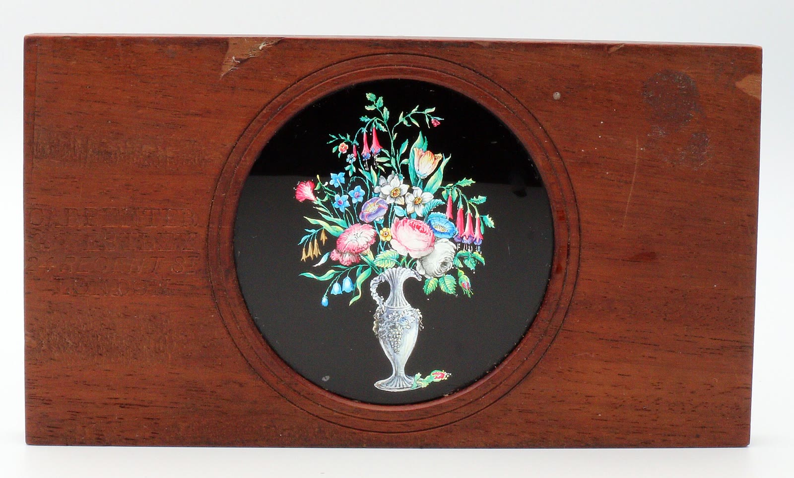 A framed magic lantern slide by Carpenter and Westley of London with hand-painted flowers in a vase