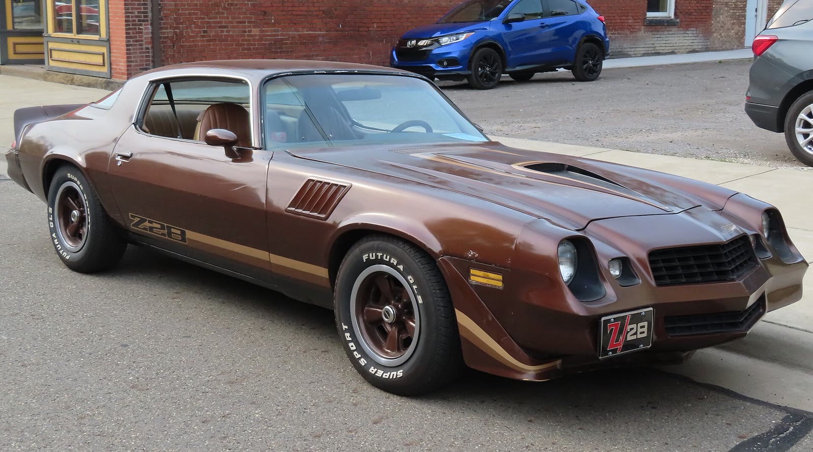 A dark brown 1979 Chevrolet Camaro Z28 parked at a car show