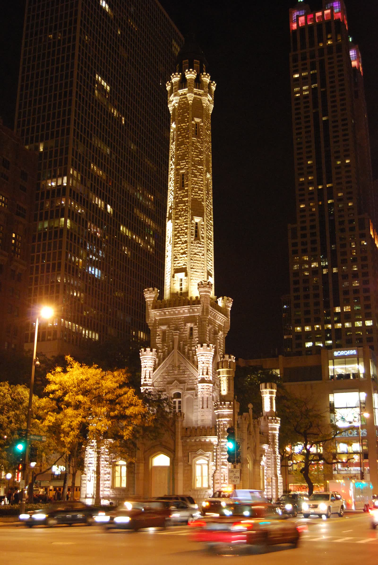 The castellated stone Chicago Water Tower lit up at night