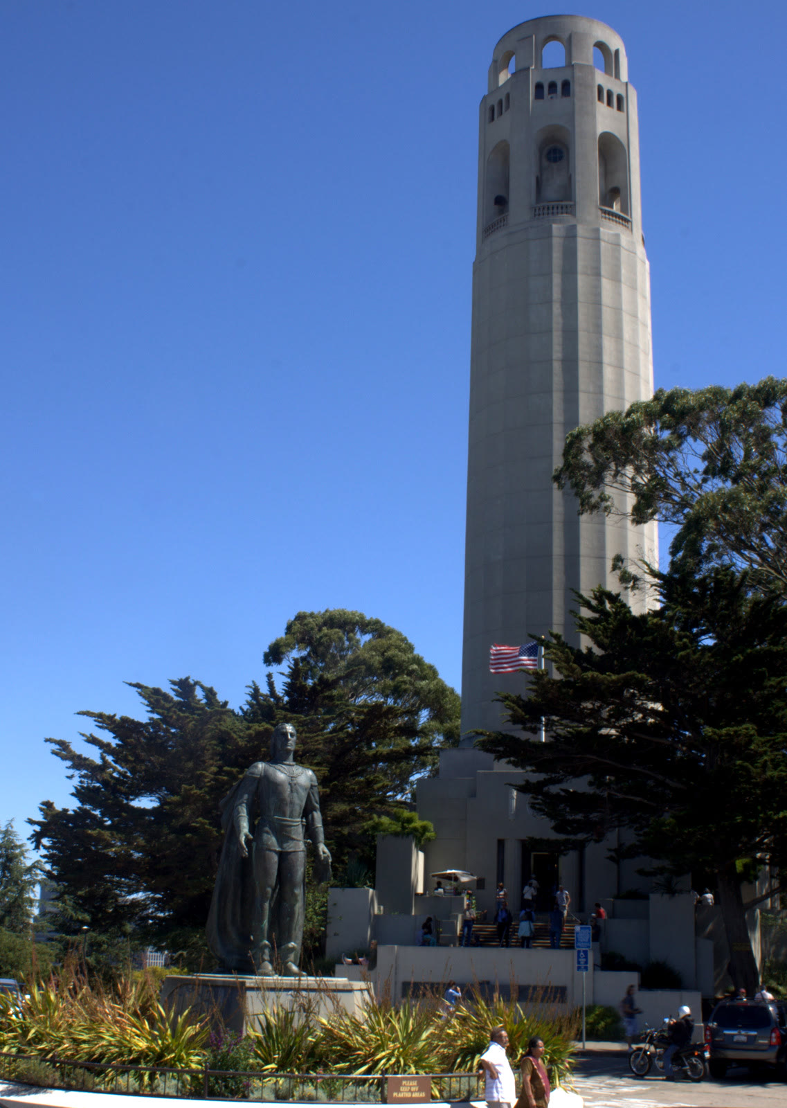 Bronze statue of Christopher Columbus on Telegraph Hill with Coit Tower behind it in San Francisco