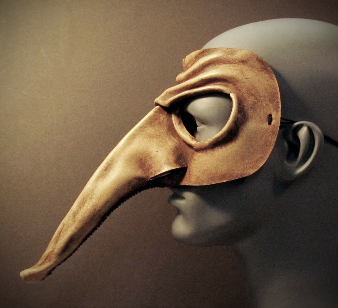 Profile view of a leather Zanni mask from the Italian commedia dell'arte tradition