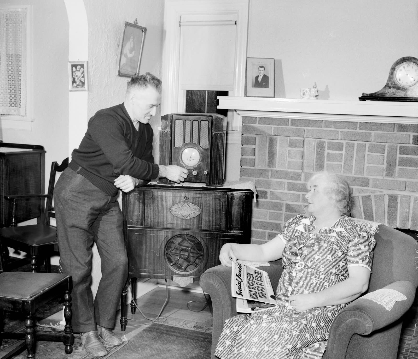 A man and a woman sitting beside a large home radio set in Michigan in 1939