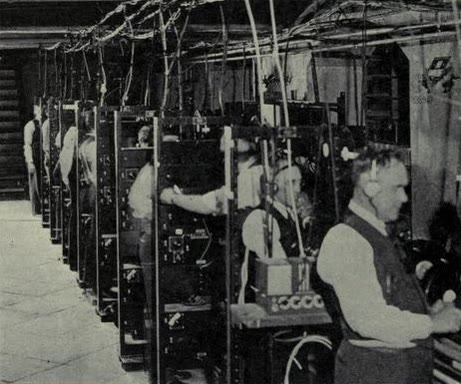 Engineers operating eight optical sound recording machines in the basement of the Academy of Music, Philadelphia