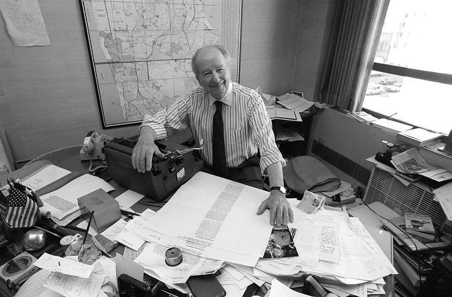 Black and white photograph of the columnist Herb Caen at his desk at the San Francisco Chronicle, 1994