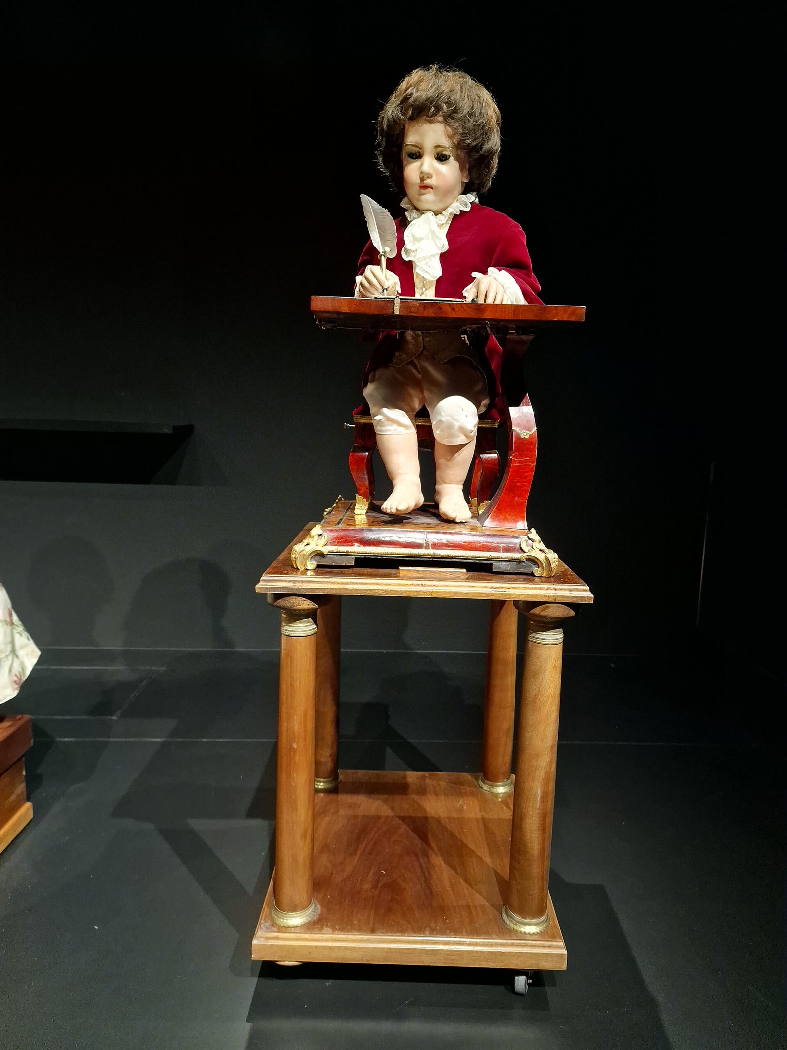 The Jaquet-Droz Writer, a doll-sized boy seated at a desk with a quill