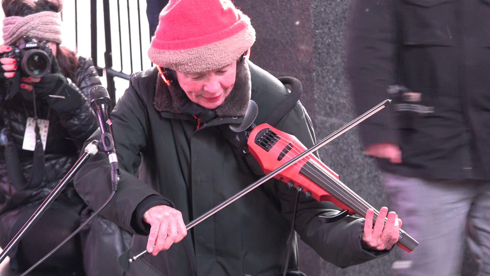 Laurie Anderson performing outdoors at her concert for dogs in Times Square, New York