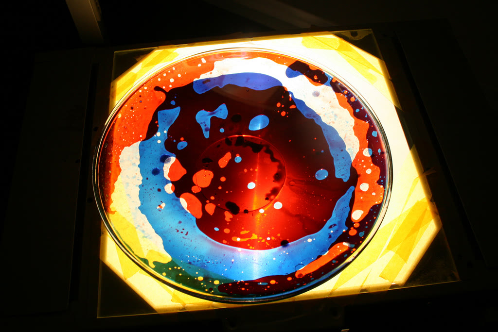 Projected bubbles of coloured liquid forming large rounded blobs of colour