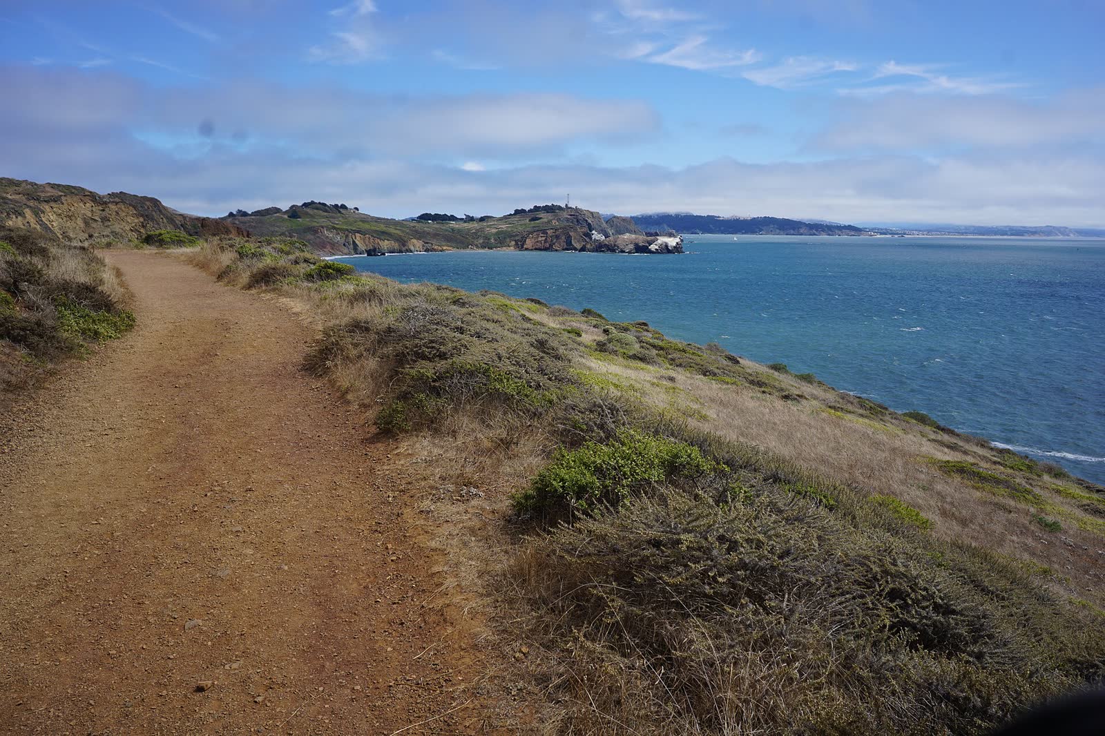 Trail running along the coast of the Marin Headlands above the ocean