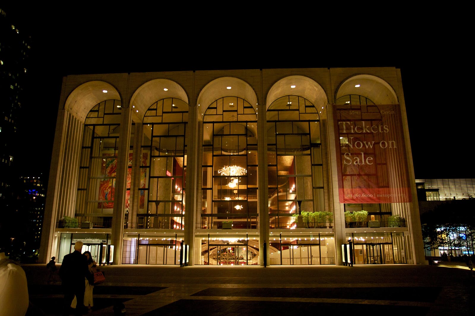 The arched glass facade of the Metropolitan Opera House at Lincoln Center lit up in the evening