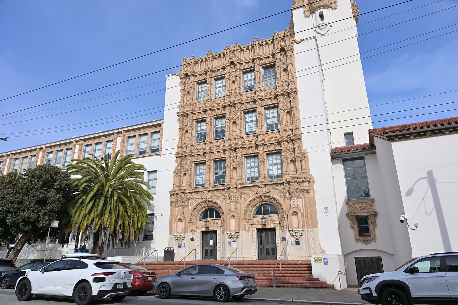 Mission High School in San Francisco, a Spanish Revival school building with a domed tower, seen from 18th Street