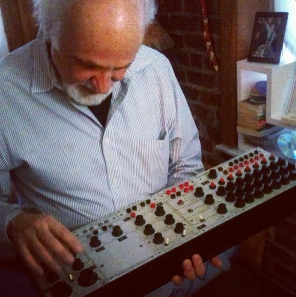 Composer Morton Subotnick in his studio beside vintage 1960s Buchla 100 synthesizer modules