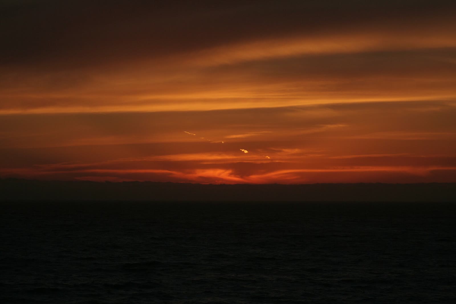 Sunset over the surf and sand of Ocean Beach in San Francisco in May 2006