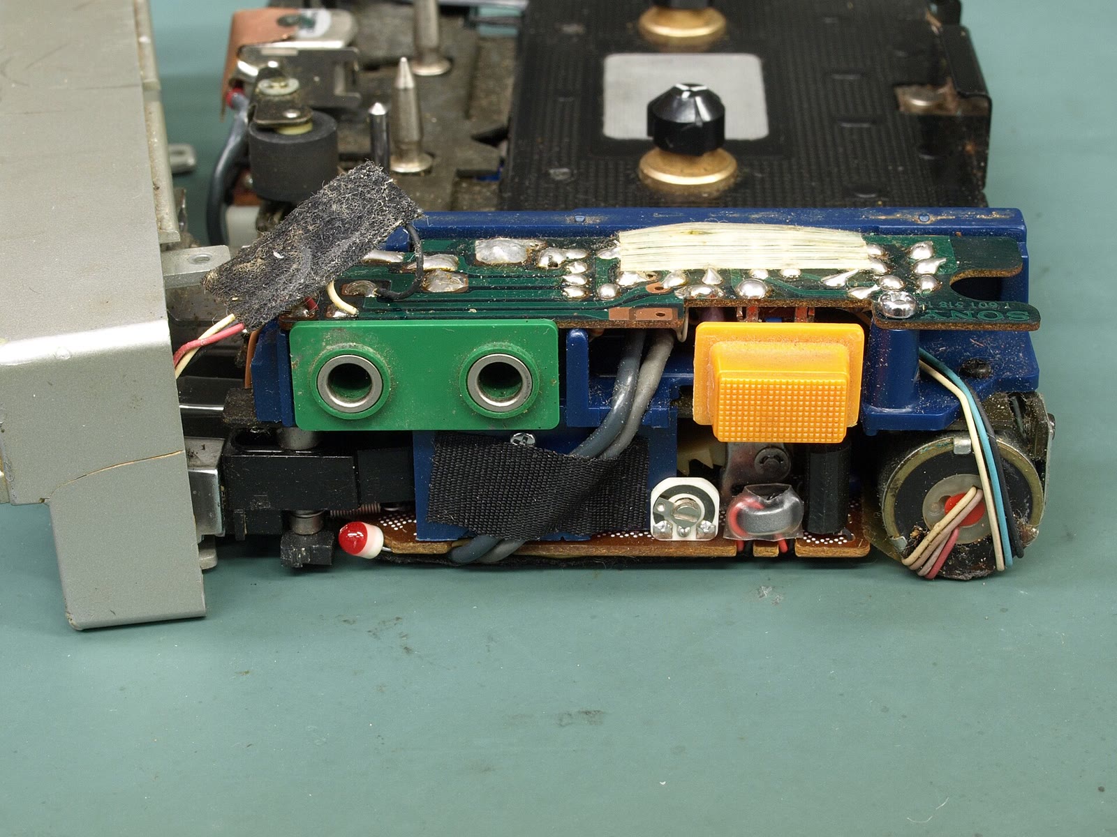 An original 1979 Sony TPS-L2 Walkman cassette player opened up to show its tape mechanism and circuit board