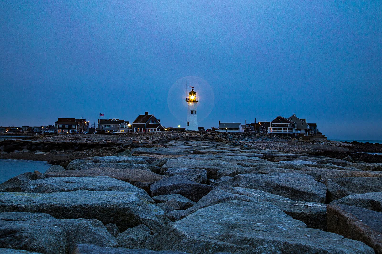 Old Scituate Lighthouse under a flat gray overcast sky
