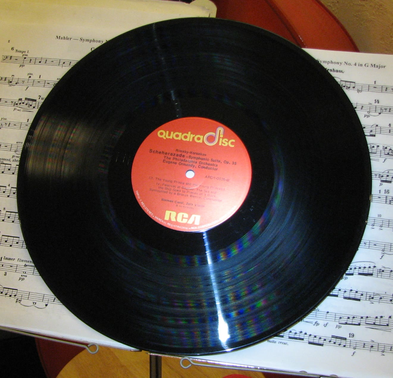 Close view of an RCA Quadradisc vinyl record, with color fringes in the reflections on its grooves