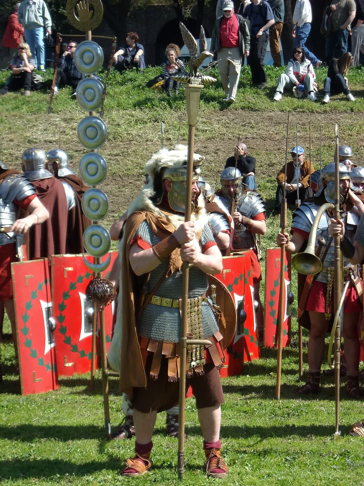 A reenactor dressed as a Roman aquilifer, holding up a legion's eagle standard