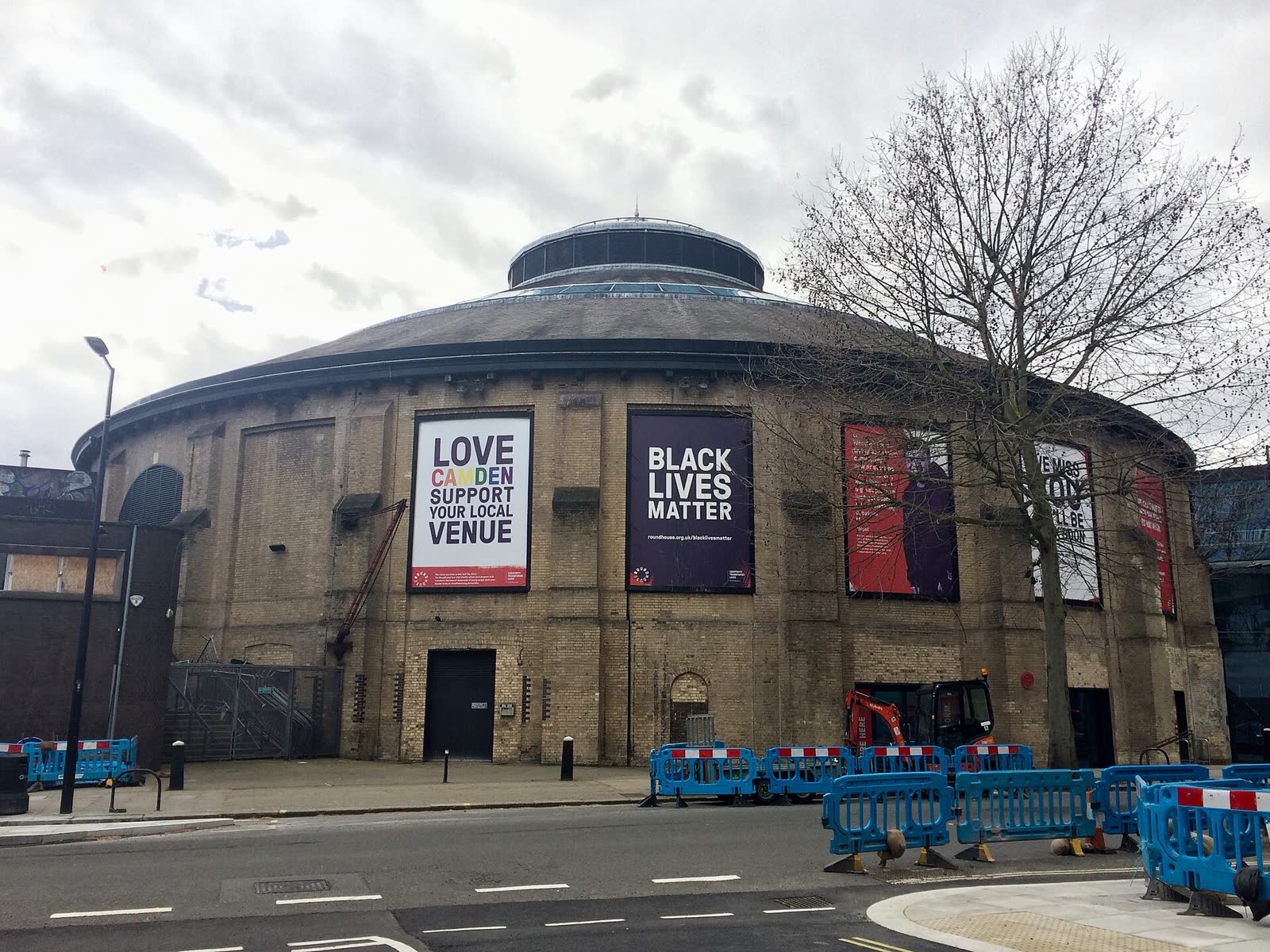 The circular brick Roundhouse seen from Chalk Farm Road in Camden, London, in March 2021