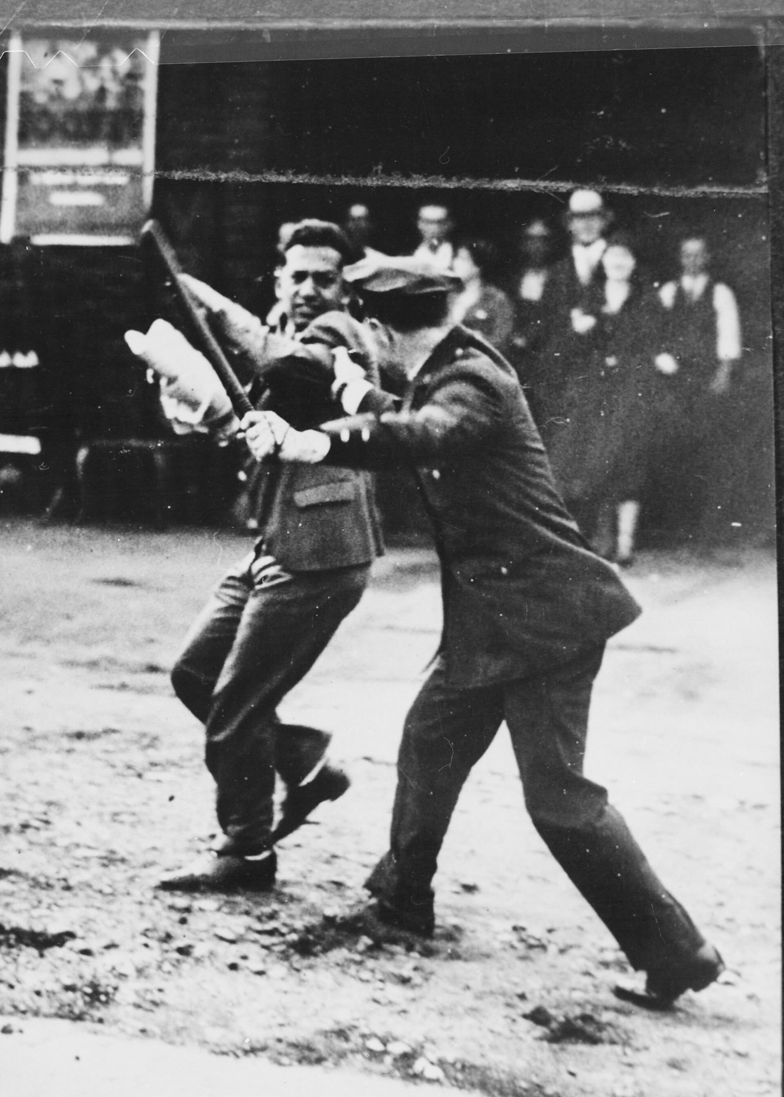 Black and white photograph of a policeman raising a nightstick against a striker during the 1934 San Francisco general strike