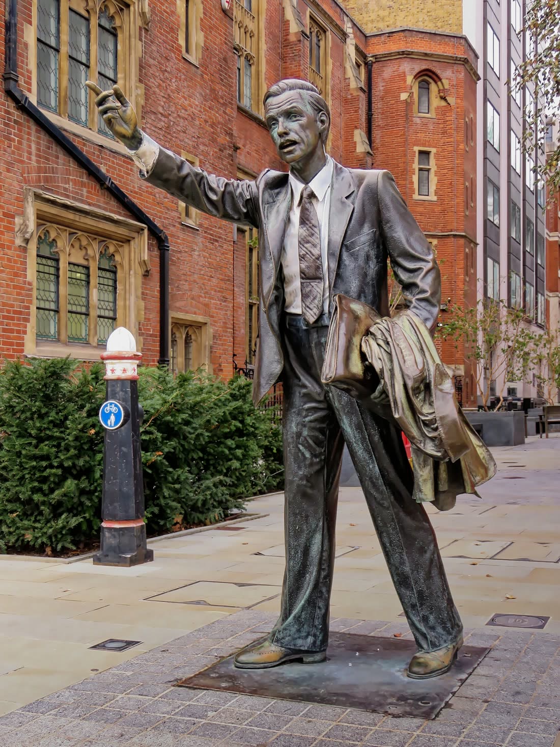 Seward Johnson's lifelike bronze figure of a man hailing a taxi on a London street