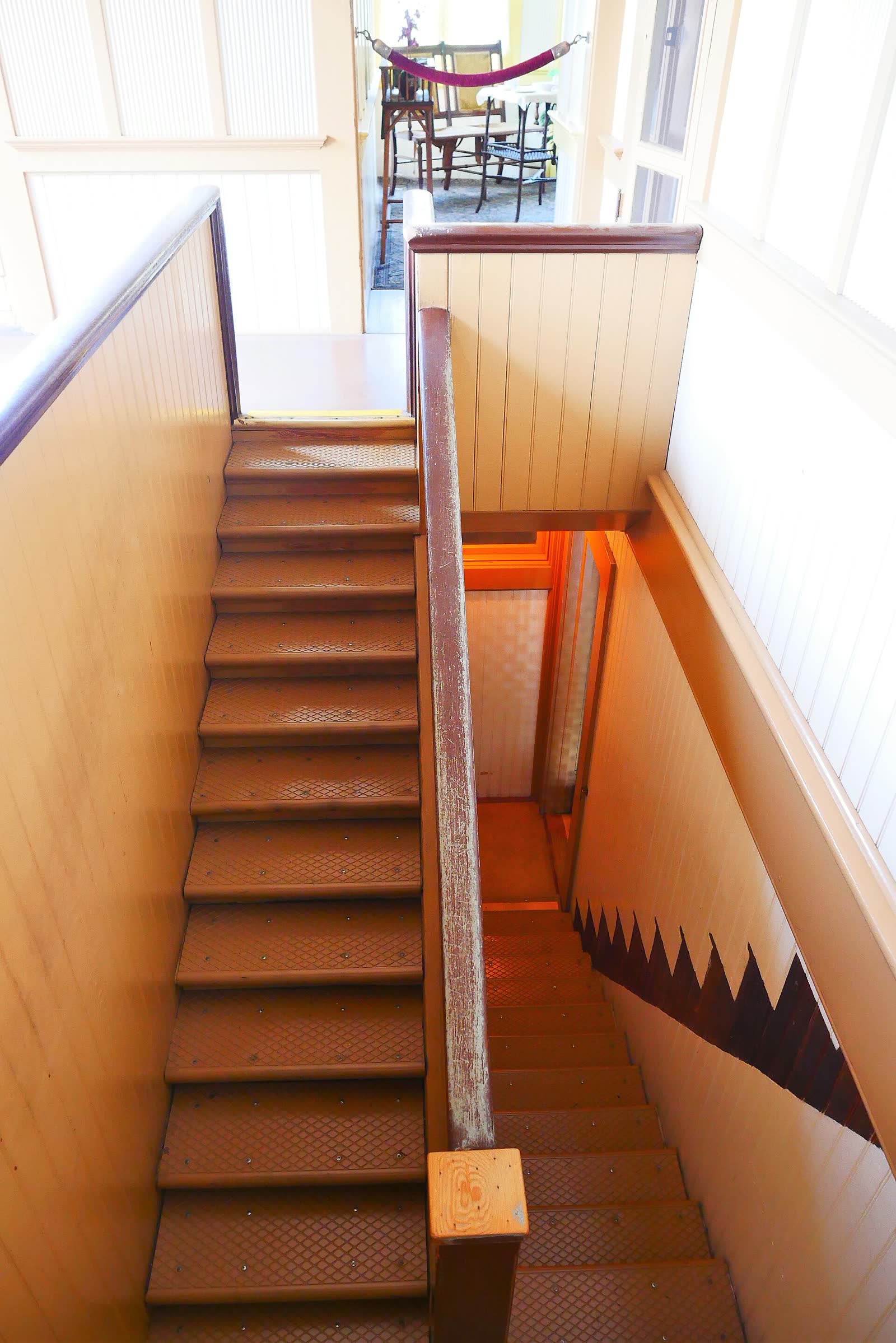 Narrow wooden staircase with very low steps inside the Winchester Mystery House