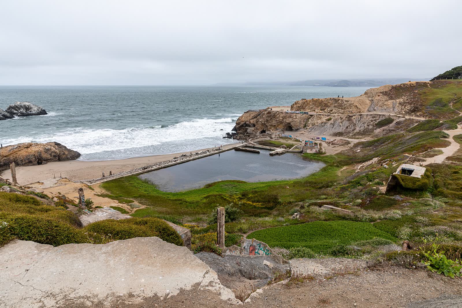 The concrete ruins and pools of the former Sutro Baths beside the ocean in San Francisco