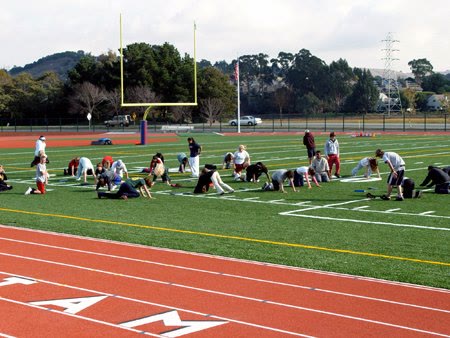 Students running on the track and field at Tamalpais High School in Mill Valley