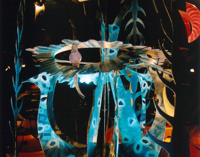A Transforming Art sculpture by Chris Hardman in which a mirror reflection completes a symmetrical form