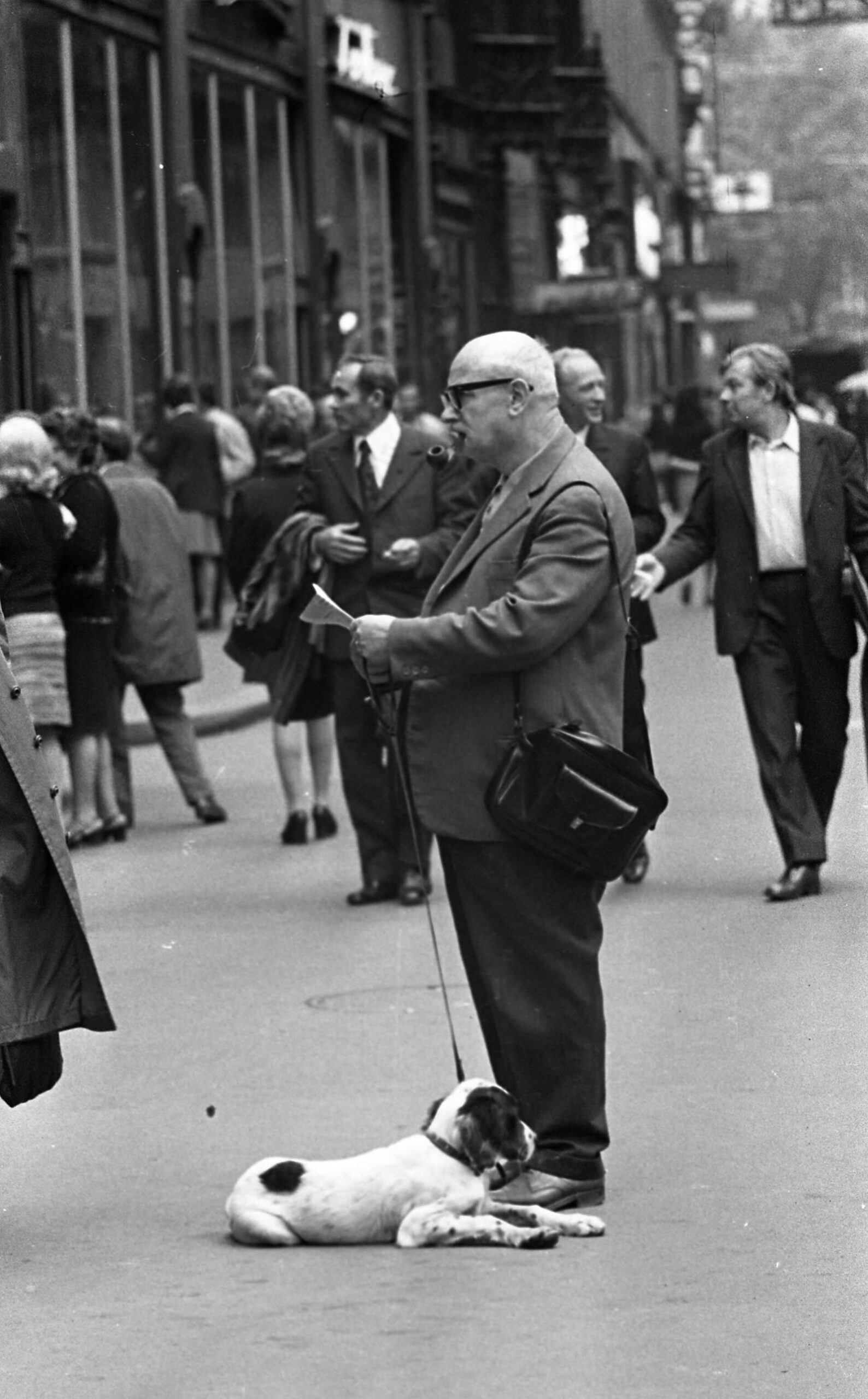 A man with a pipe and a dog on Váci utca in central Budapest in 1972