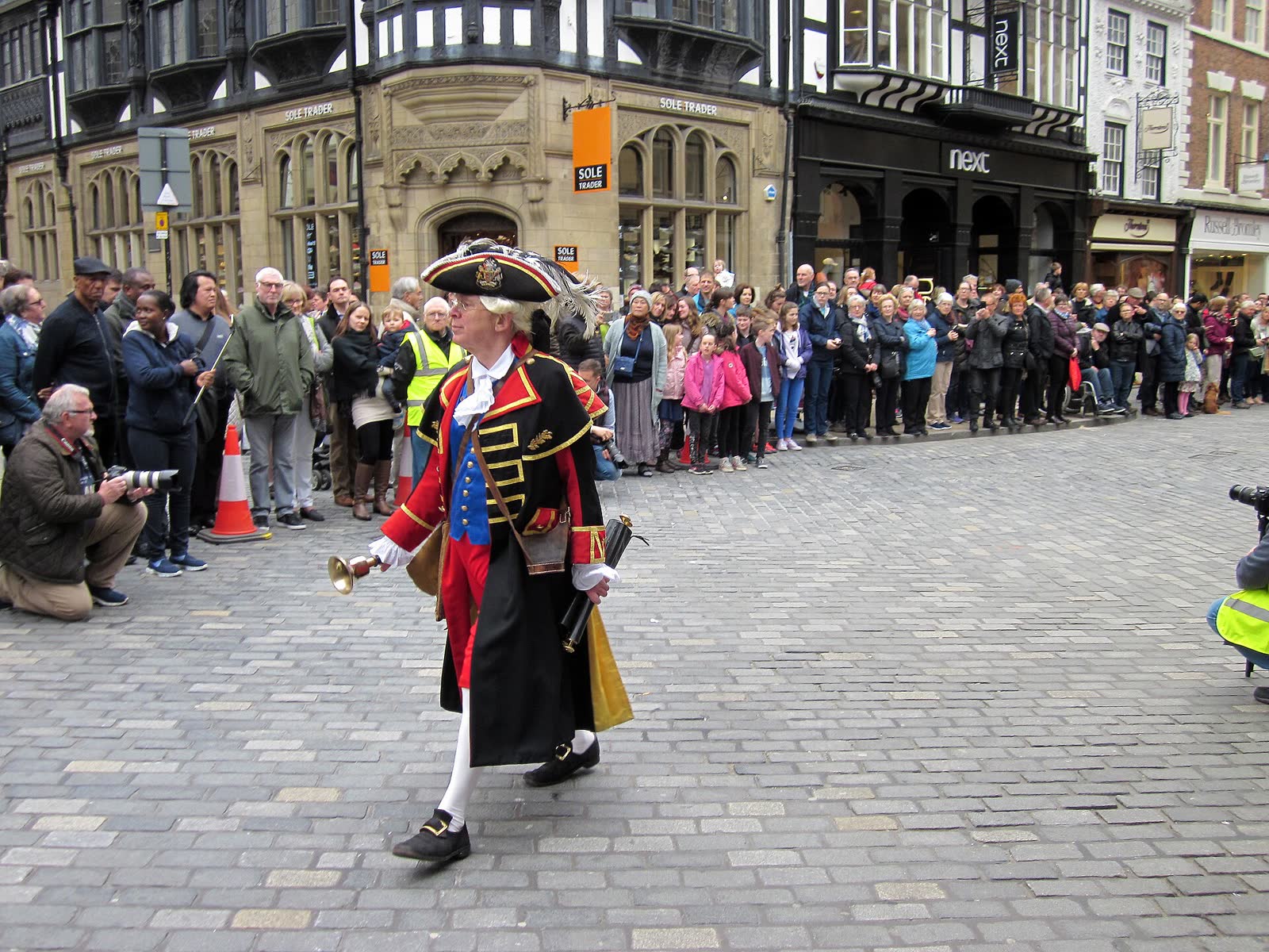 Crowd on foot at an outdoor Way of the Cross performance in the streets of Chester