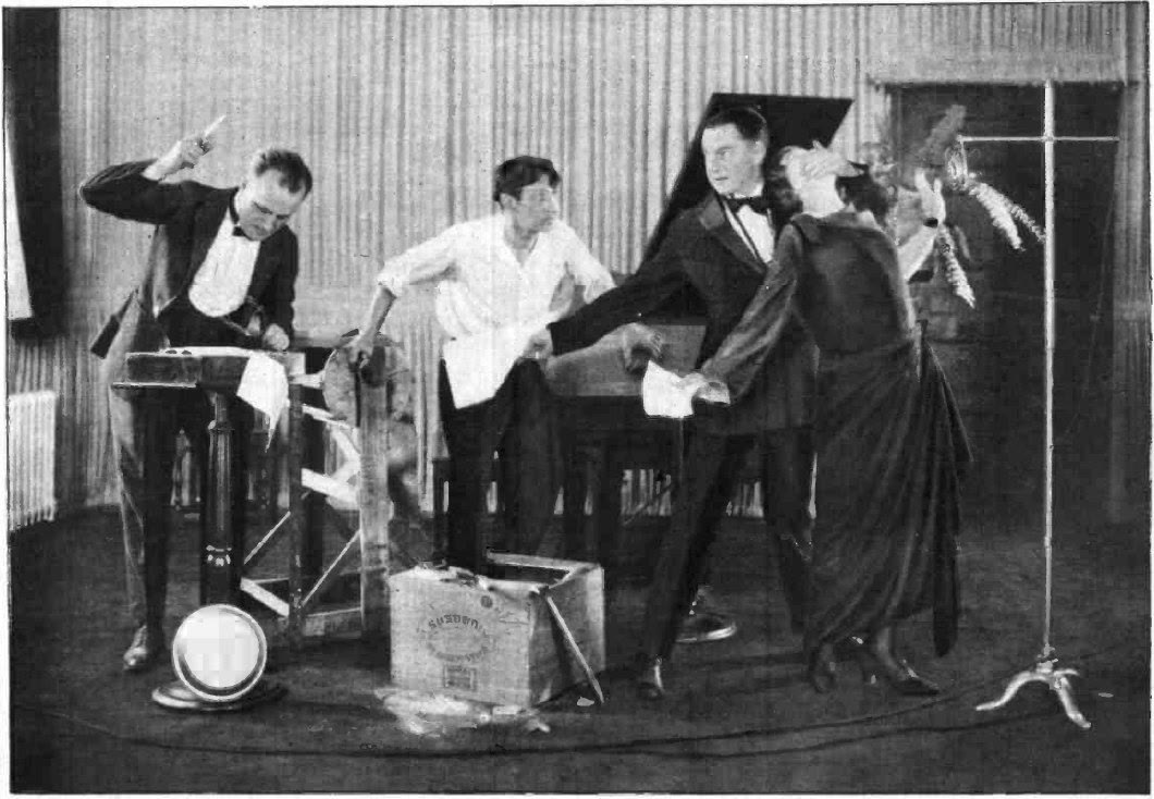 Actors performing a radio play around microphones in the WGY studio in Schenectady, New York, in 1923