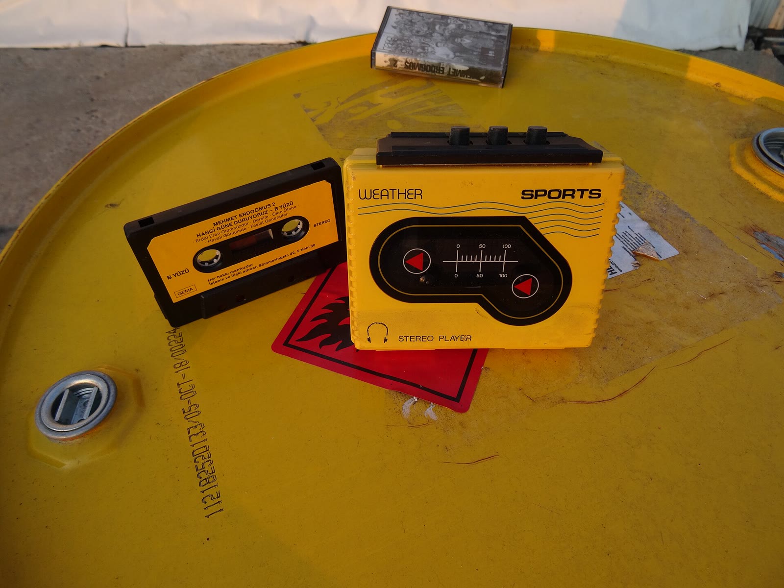 A yellow water-resistant sports cassette player with a rubber-sealed lid